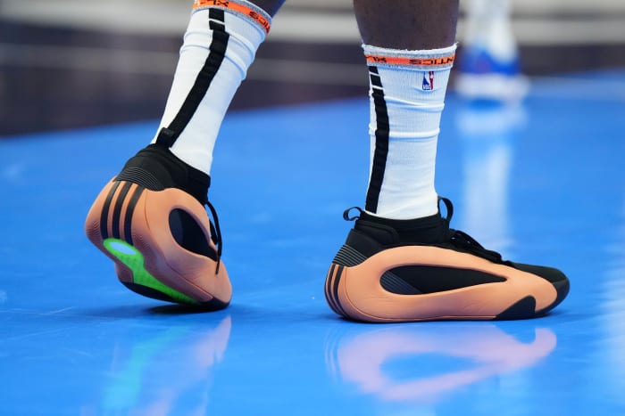 Los Angeles Clippers guard James Harden's orange and black adidas sneakers.
